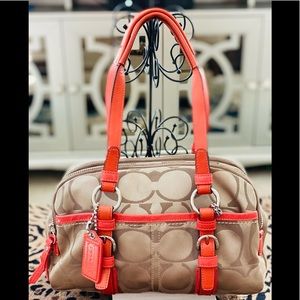 Signature Logo COACH Handbag with coral leather accents.